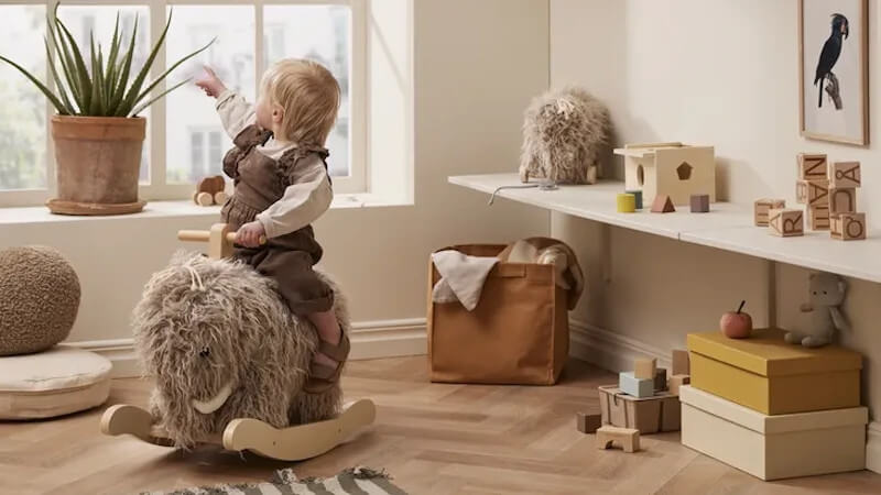 enfant sur un cheval a bascule de la marque kids concept