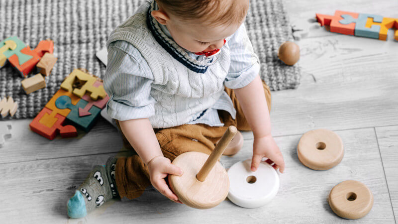 un enfant jouant avec un jouet a empiler en bois